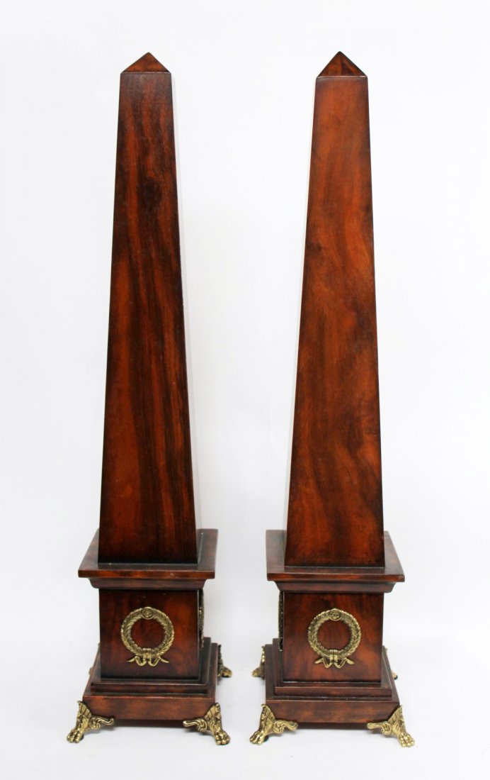Pair of Maitland Smith obelisks: Pair of Maitland Smith obelisks in mahogany with gilt bronze wreath decoration. 29"h x 7" sq at base.