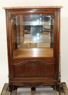 French Provincial carved oak vitrine: French Provincial carved oak vitrine with beveled glass mirrored back and marble top. Early 20th century. 58"h x 44"w x 8"d