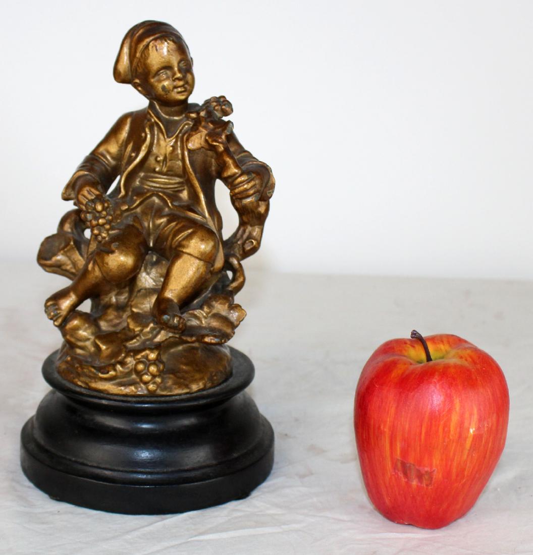 French gilt statue of seated boy with grapes: French gilt statue of seated boy with grapes on wooden plinth. 20th century. 9 1/2"h x 5 1/4"w