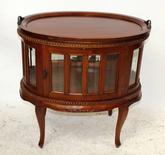 Mahogany oval chocolate cabinet: Mahogany oval chocolate cabinet. 30"h x 28 1/2"w x 19"d