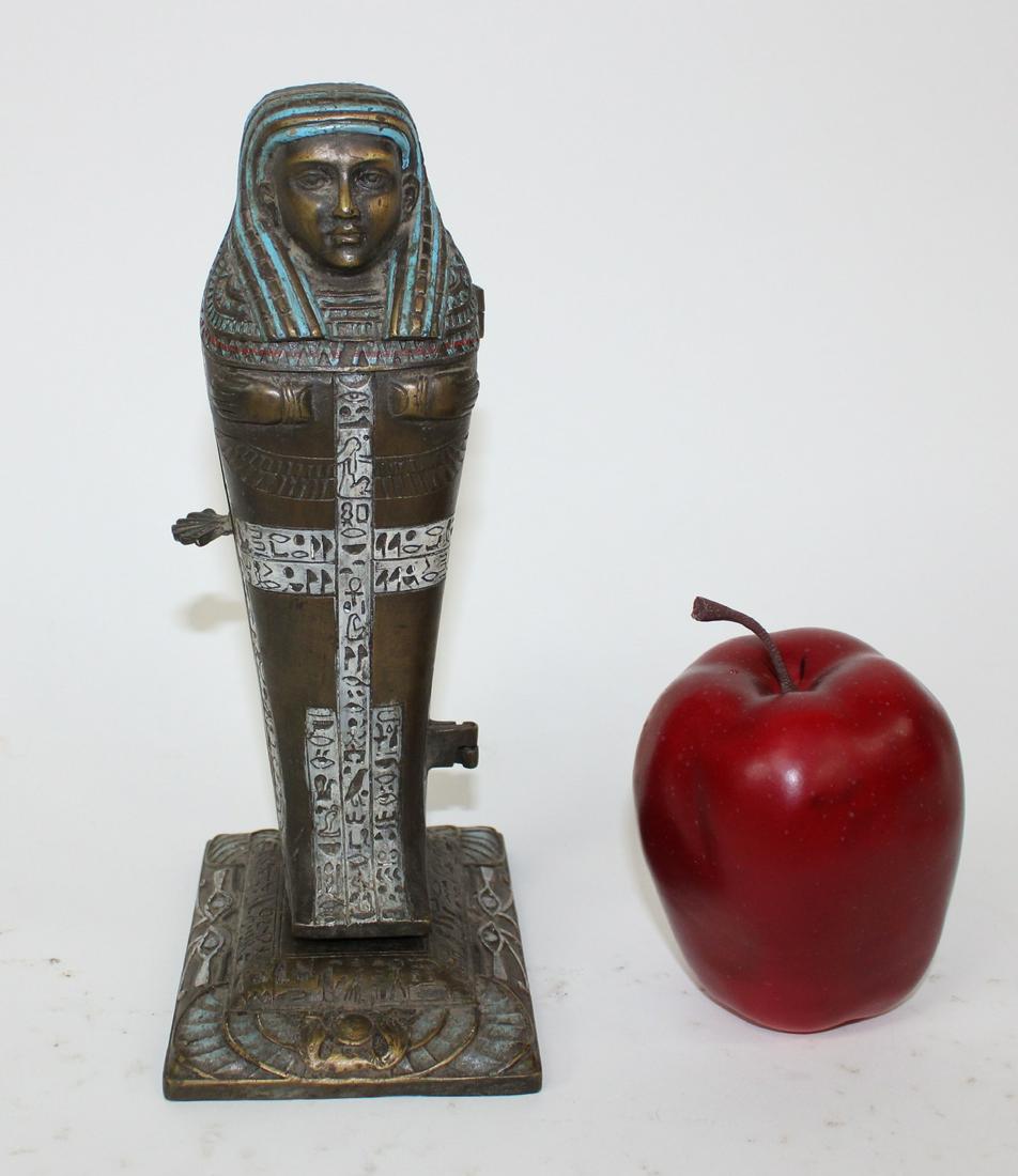 Cold painted bronze Egyptian erotic figurine: Cold painted bronze erotic figurine modelled as Egyptian sarcophagus that opens to reveal a nude figure. Marked on back with a B and Namc rew. Design by Franz Bergman. 8.75"h x 3.5"w x 5"d
