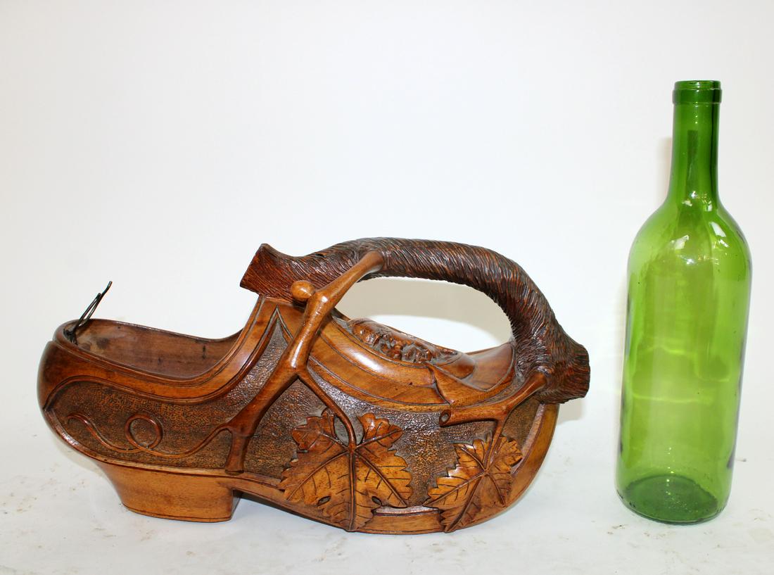 French carved walnut clog wine bottle holder: French carved walnut clog wine bottle holder with music box. Artist signed. Early 20th century. 7 1/4"h x 14"w x 5 1/4"d