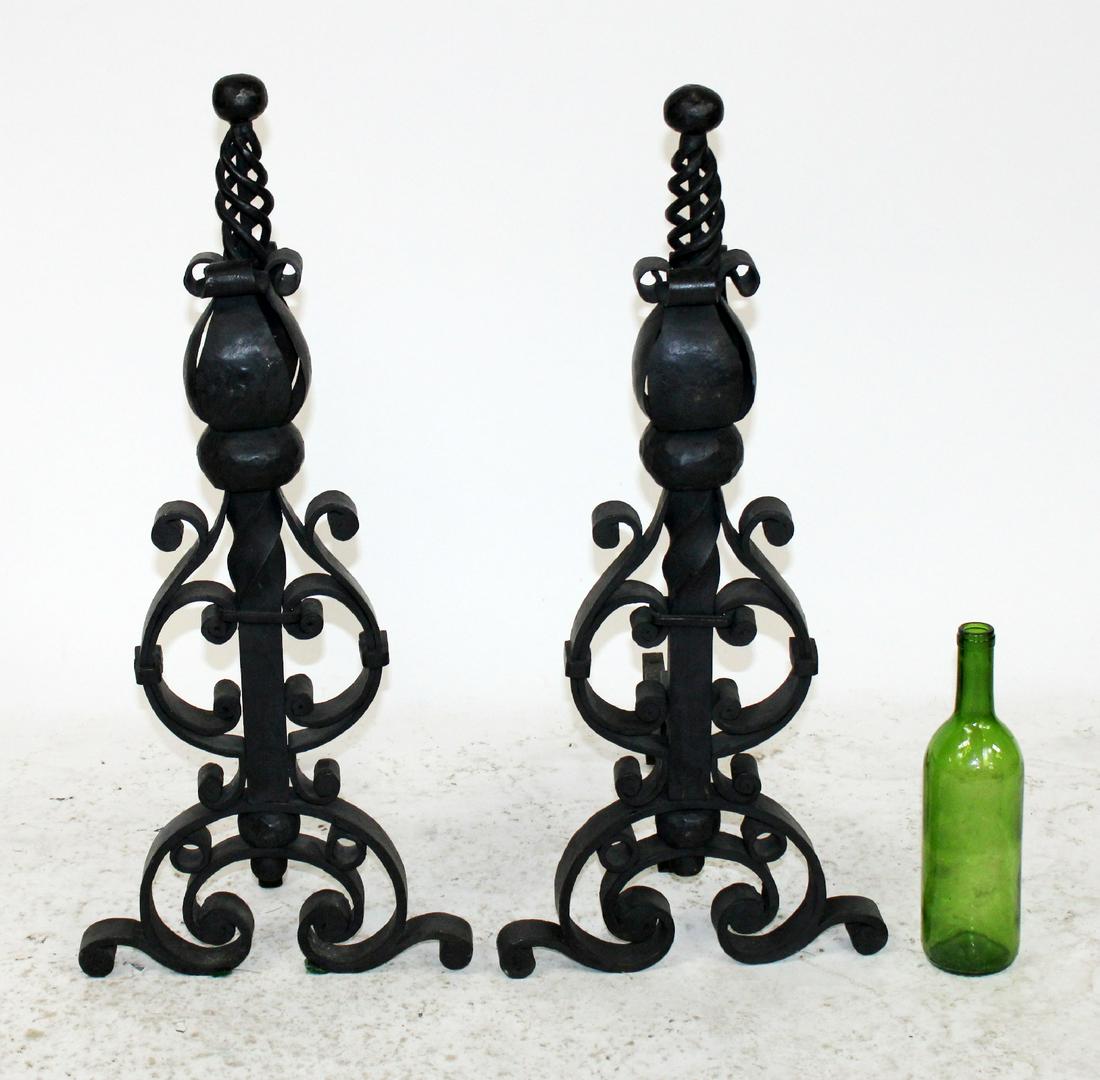 Pair of scrolled cast iron andirons: Pair of scrolled black cast iron fireplace andirons. 20th century. 27 1/2"h x 12"w x 14"d