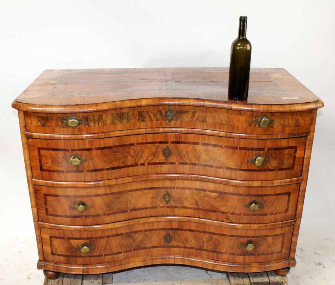 German 18th century marquetry commode: German 18th century 4 drawer marquetry commode Serpentine front. Inside top drawer, hidden storage and locking mechanism to lock 3 lower drawers.33"h x 47 1/2"w x 25 1/2"d
