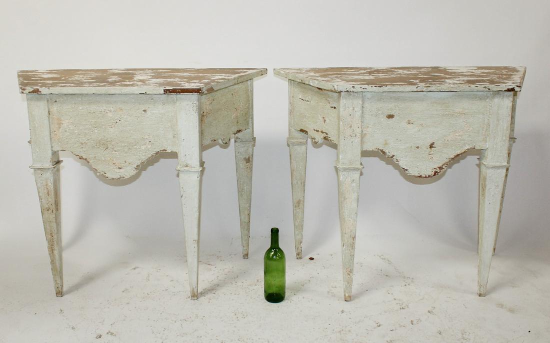 Pair Tuscan painted console tables on tapered legs: Pair of Tuscan painted pine console tables on tapered legs with distressed painted tops. 20th century. 31"h x 39 1/2"w x 17 1/2"d