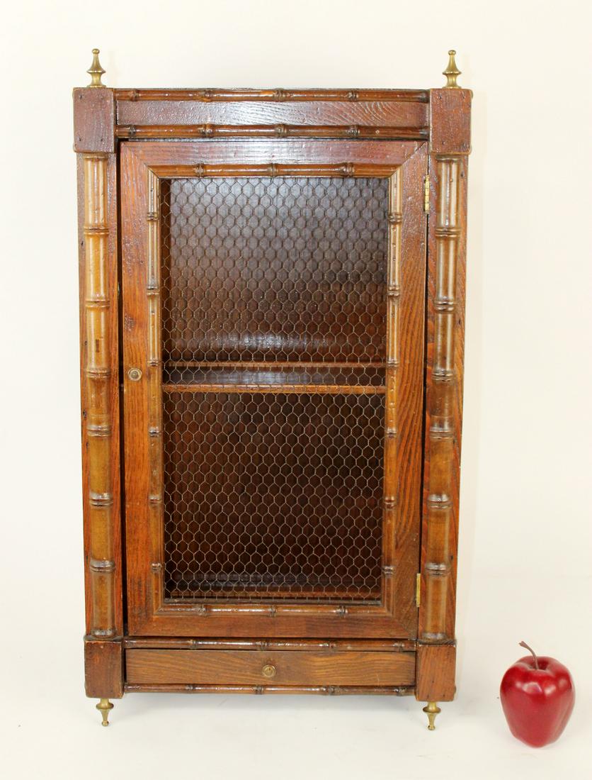 Italian faux bamboo wall cabinet: Italian faux bamboo wall cabinet with wire door, lower drawer and brass finials. 29"h x 16"w x 9"d