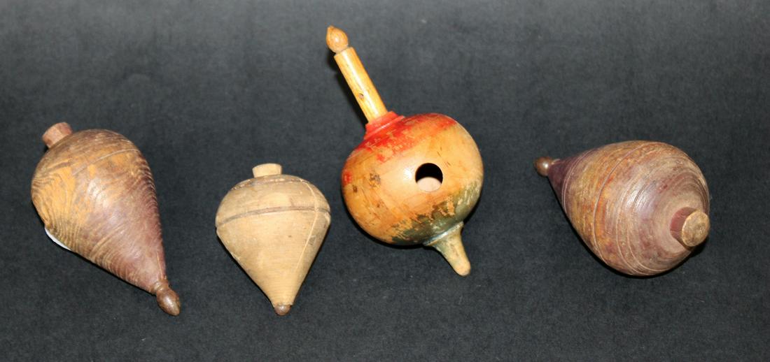 4 antique wooden spinning tops: 4 antique wooden spinning tops. Sizes range from 4 1/4"h x 2 1/2"w- 2 1/2"h x 2"w