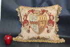 Needlepoint throw pillow with crest