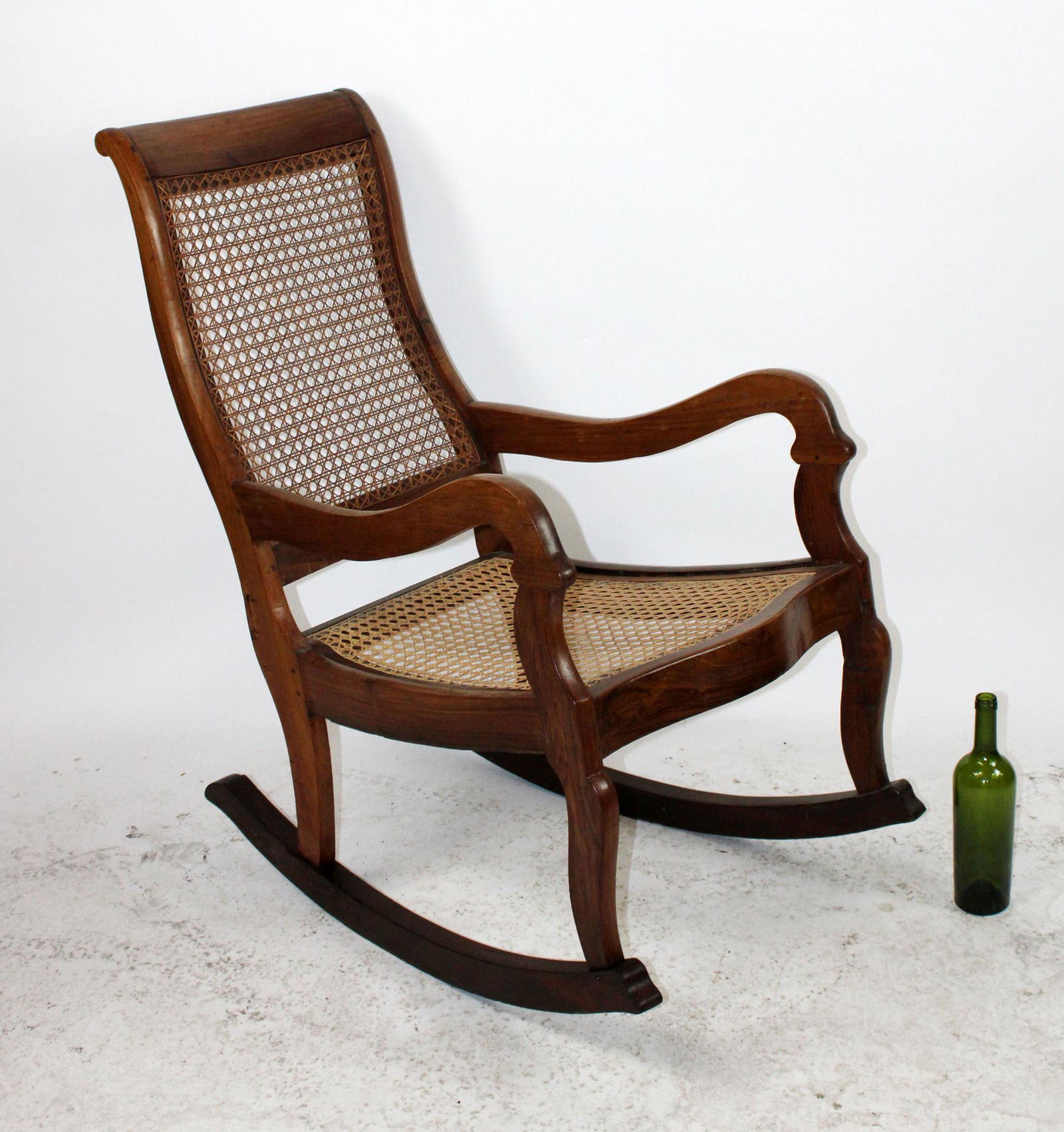 French walnut caned rocking chair: French walnut caned rocking chair. 20th century. 39"h x 23"w x 35"d