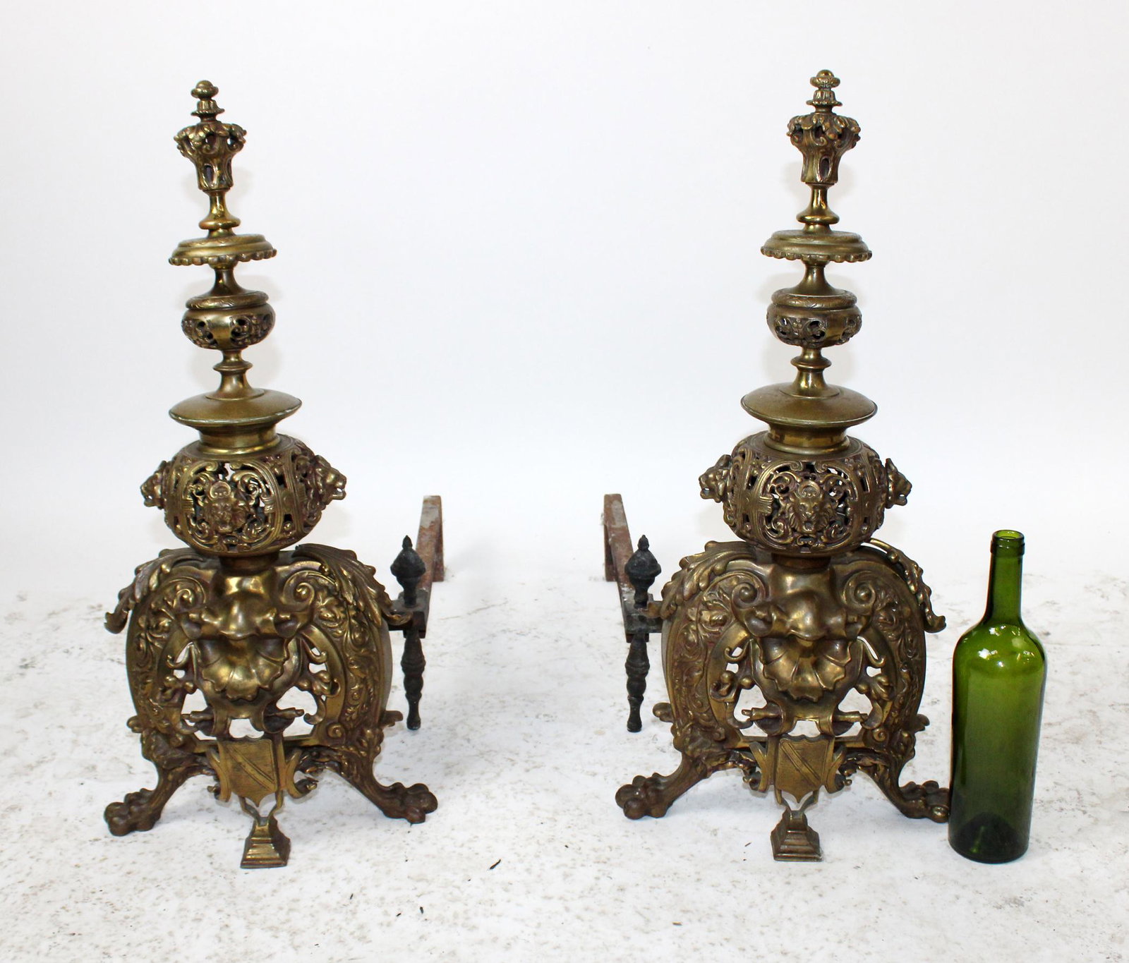 French Renaissance brass andirons with lion heads: French Renaissance brass filigree andirons with lion heads on paw feet. Early 20th century. 27"h x 13"w x 28"d