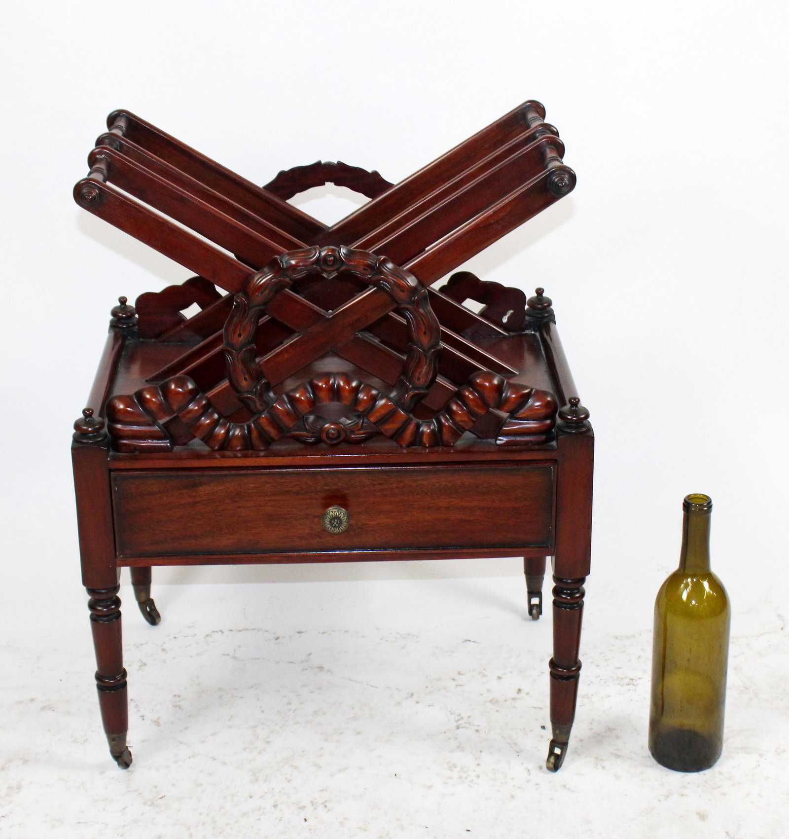 William IV style canterbury with carved wreath: William IV style mahogany canterbury with carved wreath. On castors. Late 20th century. 24 1/2"h x 19 1/4"w x 13 13/4"d