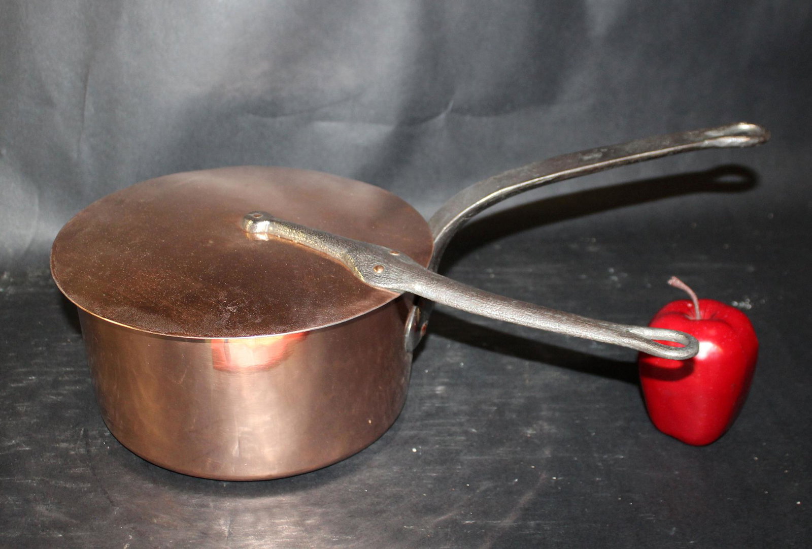 French polished copper pot with lid: French polished copper pot with lid and iron handles. Pot measures 5"h x 19 1/2"l x 8 3/4" dia, Lid measures 16 1/2"l x 10" dia