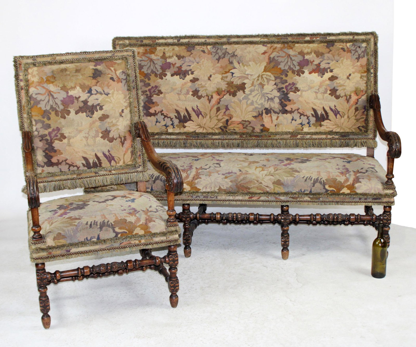 French Louis XIV style walnut settee and armchair: French Louis XIV style carved oak settee and armchair in tapestry upholstery. Late 19th century. Chair measures 46"h x 27"w x 26"d, seat height 19", Settee measures 46"h x 67"l x 30"d, seat height 20"