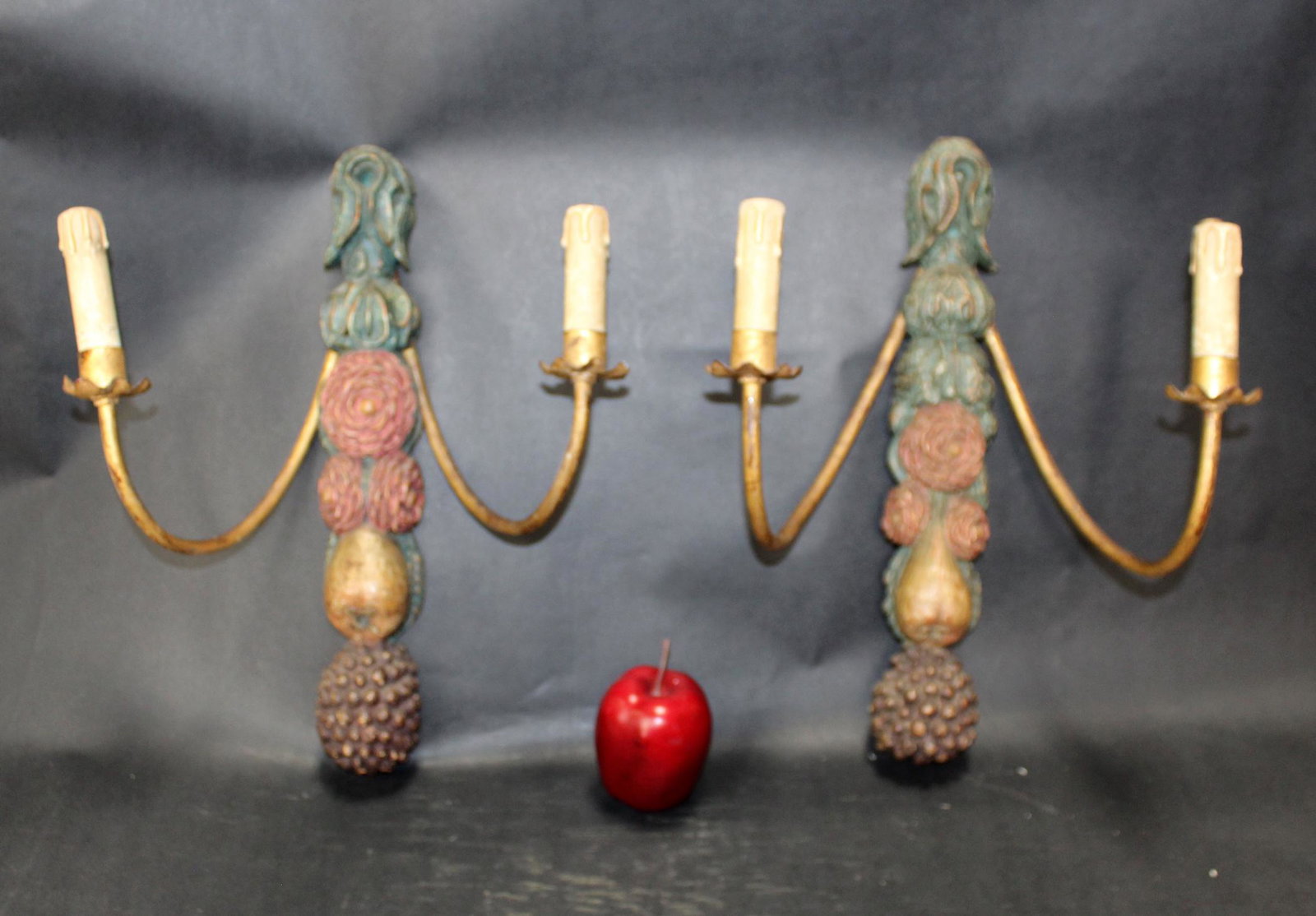 Pair of Italian polychrome candle sconces: Pair of Italian polychrome carved wooden candle sconces decorated with flowers and fruit. Late 19th century. 17"h x 14"w