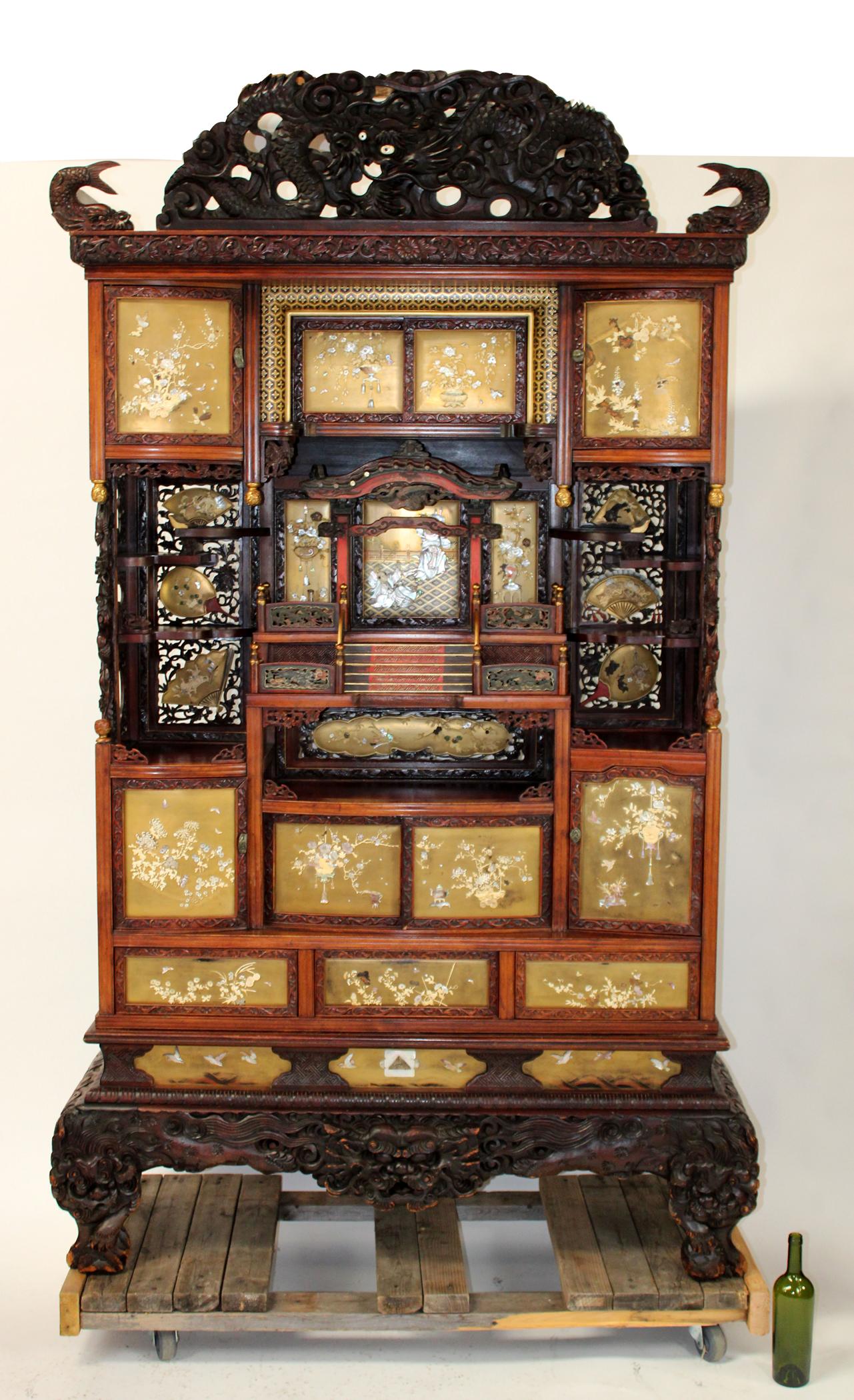 Japanese Meiji Shibyama cabinet: Japanese Meiji period Shibiyama cabinet with elaborate carved and pierce carved dragon crest. Doors are gold lacquered and decorated with mother of pearl. Circa 1880-1890. 91 1/2"h x 56"w x 18"d
