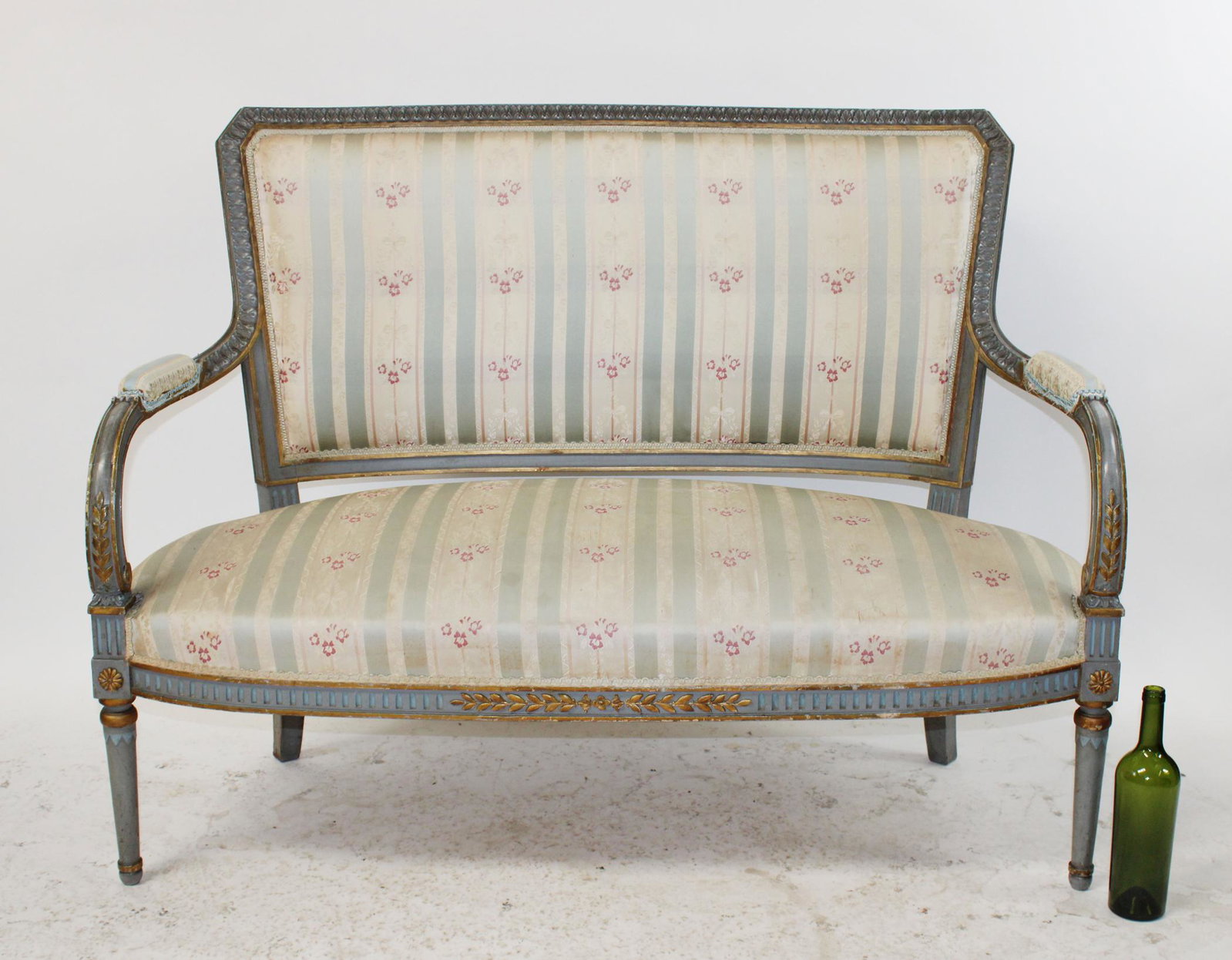 French Louis XVI style painted settee: French Louis XVI style painted settee with silk upholstery. Gold detail on frame. Early 20th century. 39 1/4"h x 50 1/2"w x 25 1/2"d