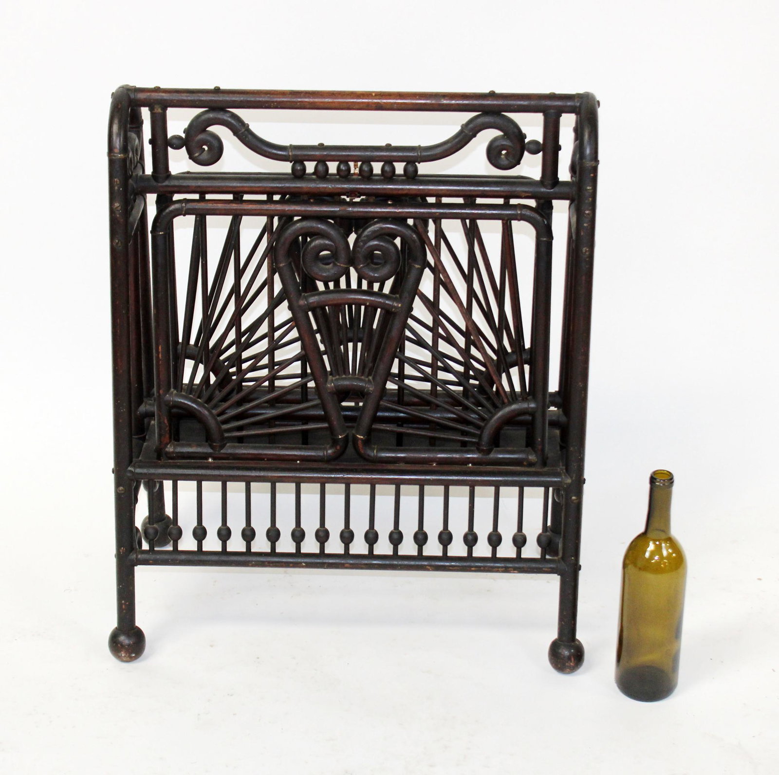 Victorian fretwork folding magazine rack: Antique Victorian faux bentwood folding magazine rack with stick and ball fretwork. Sides fold down. American, Circa 1900. Attributed to Ferguson Furniture Co NY. 26 1/2"h x 22 1/2"w x 13-25"w