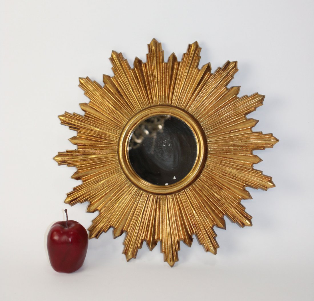 Cast gilt sunburst mirror: Cast resin gilt sunburst mirror. Circa 1990's. 17"diam. Mirror 5 1/4"diam