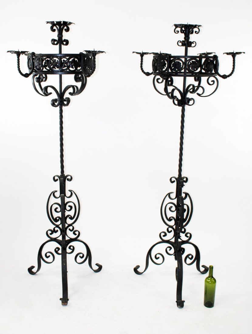 Pair of black iron scrolled candle torcheres: Pair of black iron scrolled candle torcheres. Late 20th century. 77"h x 44" dia