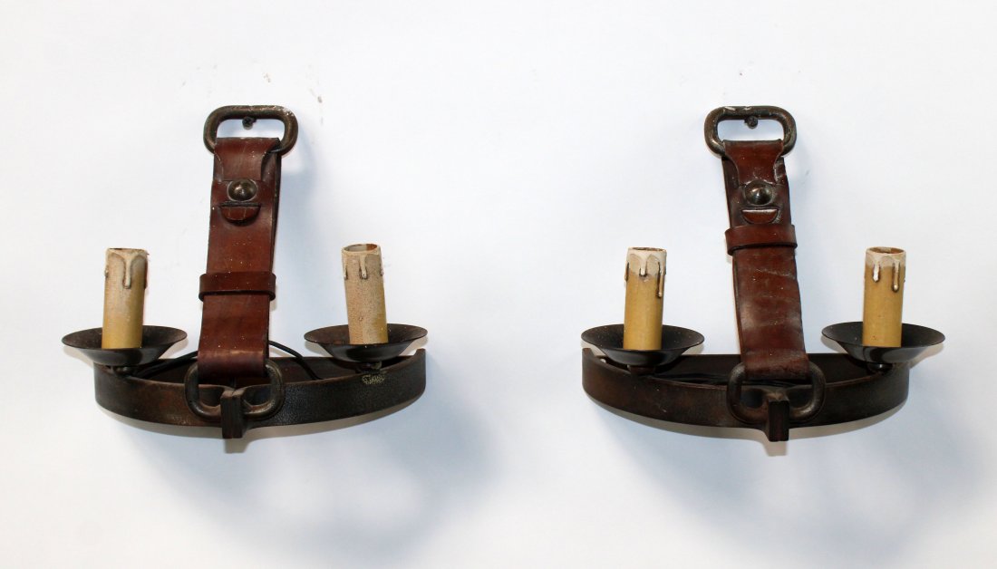 Pair of French Art Deco iron and leather sconces: Pair of French Art Deco iron and leather strap and buckle sconces. 20th century. 11"h x 11"w