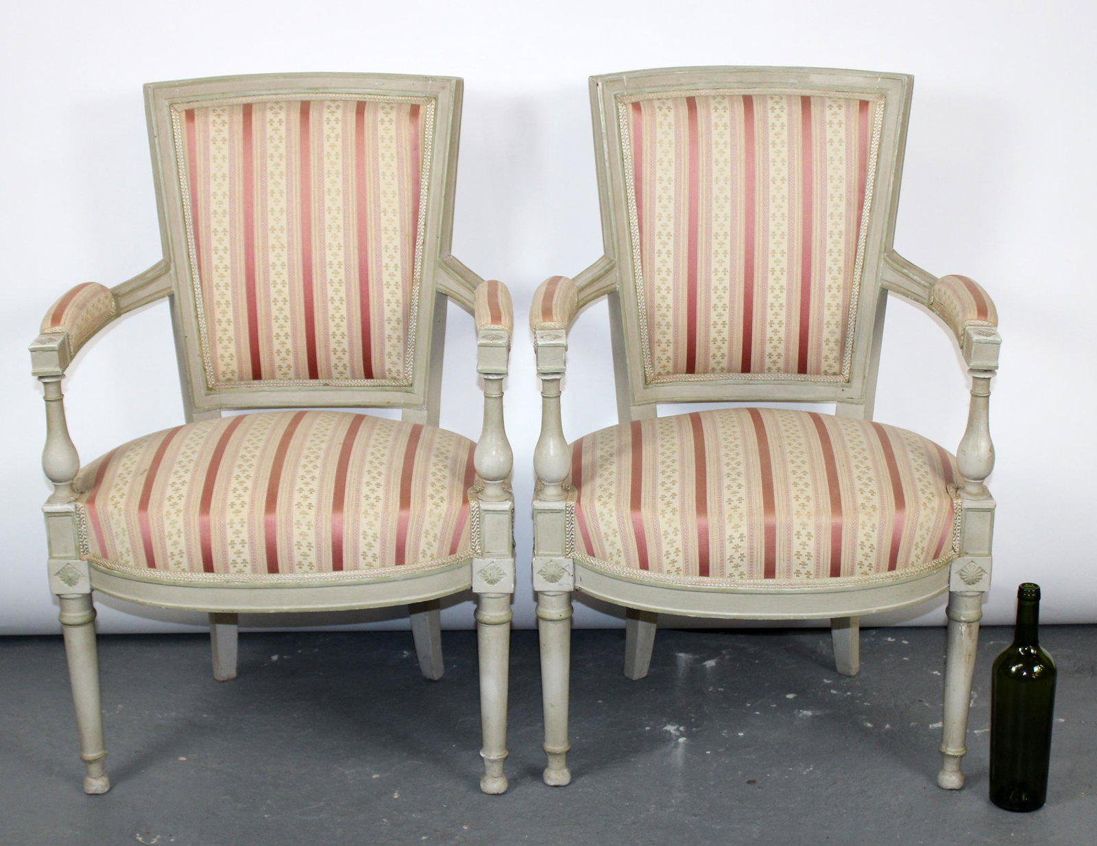 Pair of French Louis XVI style armchairs: Pair of French Louis XVI style armchairs in pink and white upholstery and painted white frames. 34 1/2"h x 23"w x 20"d, seat height 17 1/2"