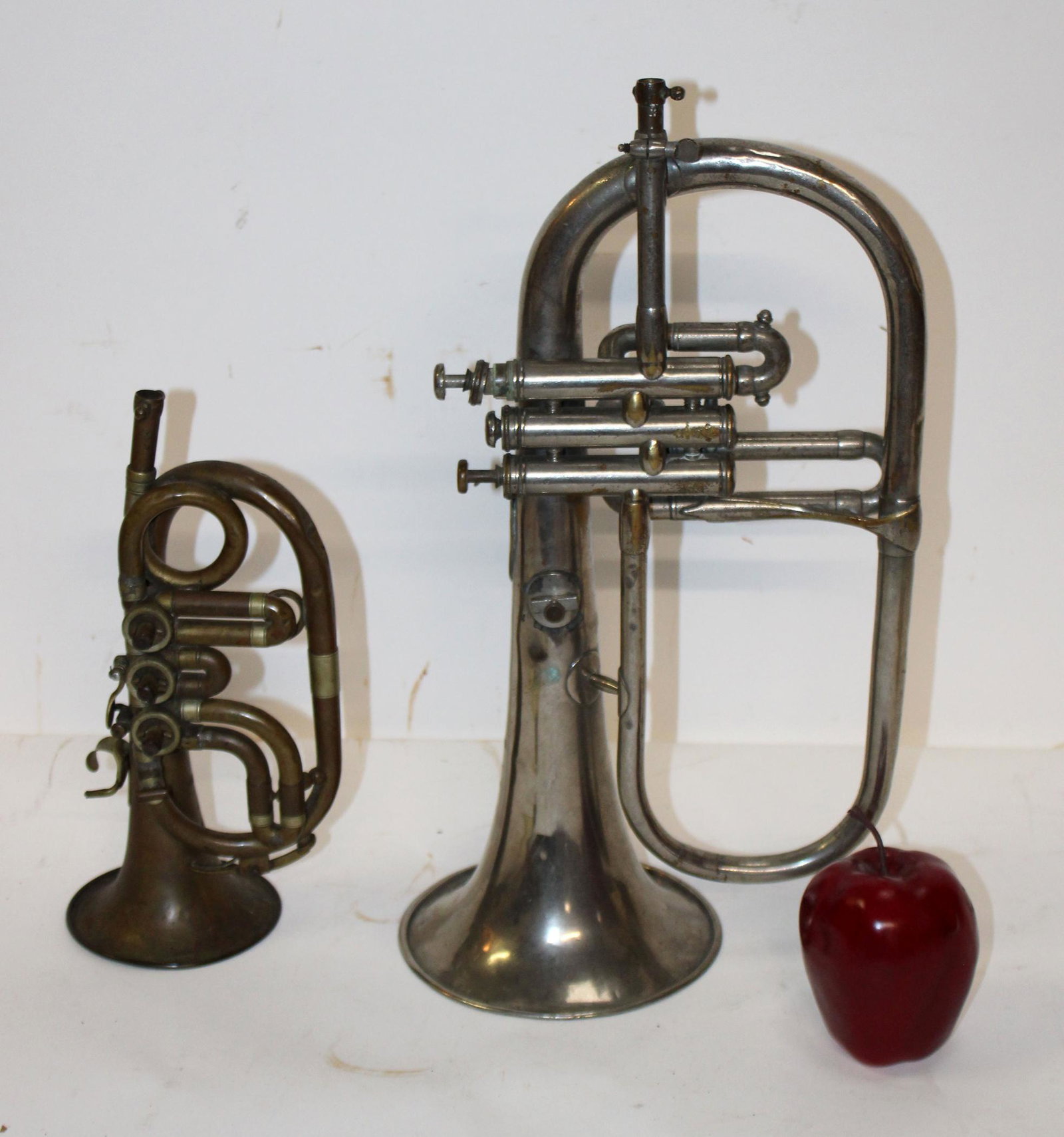 Lot of 2 vintage trumpets: Lot of 2 vintage trumpets- One marked Wurlitzer, One marked Belgium. 11"h x 6 1/2"w x 4"d and 17 1/2"h x 9 1/2"w x 6"d