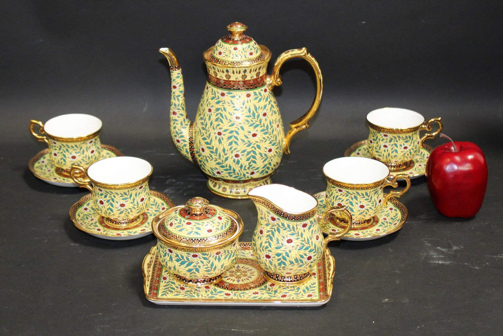 Benjarong Royal bone china tea set: Benjarong Royal bone china tea set in fitted case. Service for 4. Tea pot 8 1/2"h, saucers 5 1/2" dia, cups measure 3 1/2"h, creamer measures 4 1/2"h, sugar measures 4"