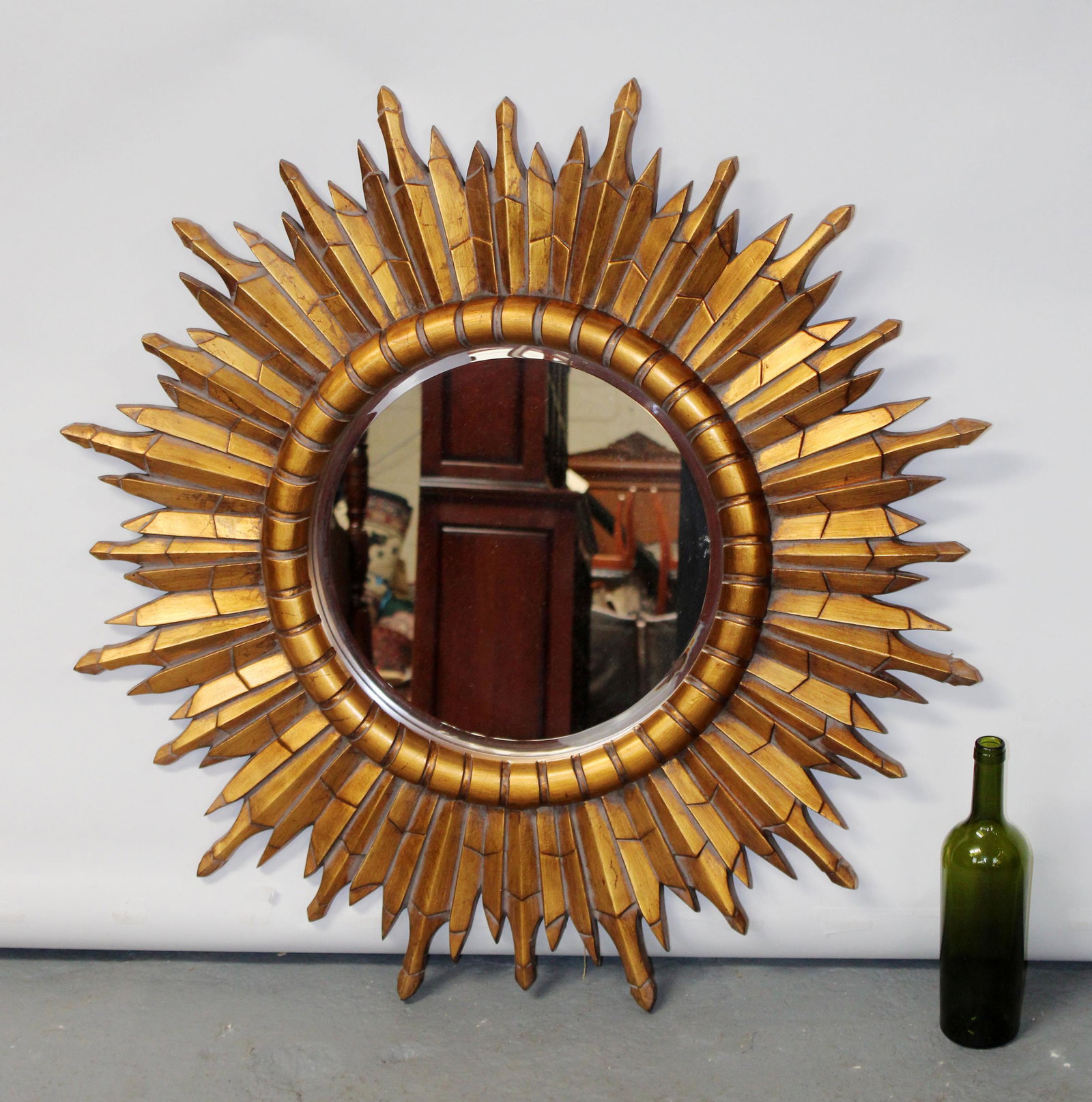Sunburst mirror with painted gilt finish: Sunburst mirror in gold painted finish. 21st century. 36" dia
