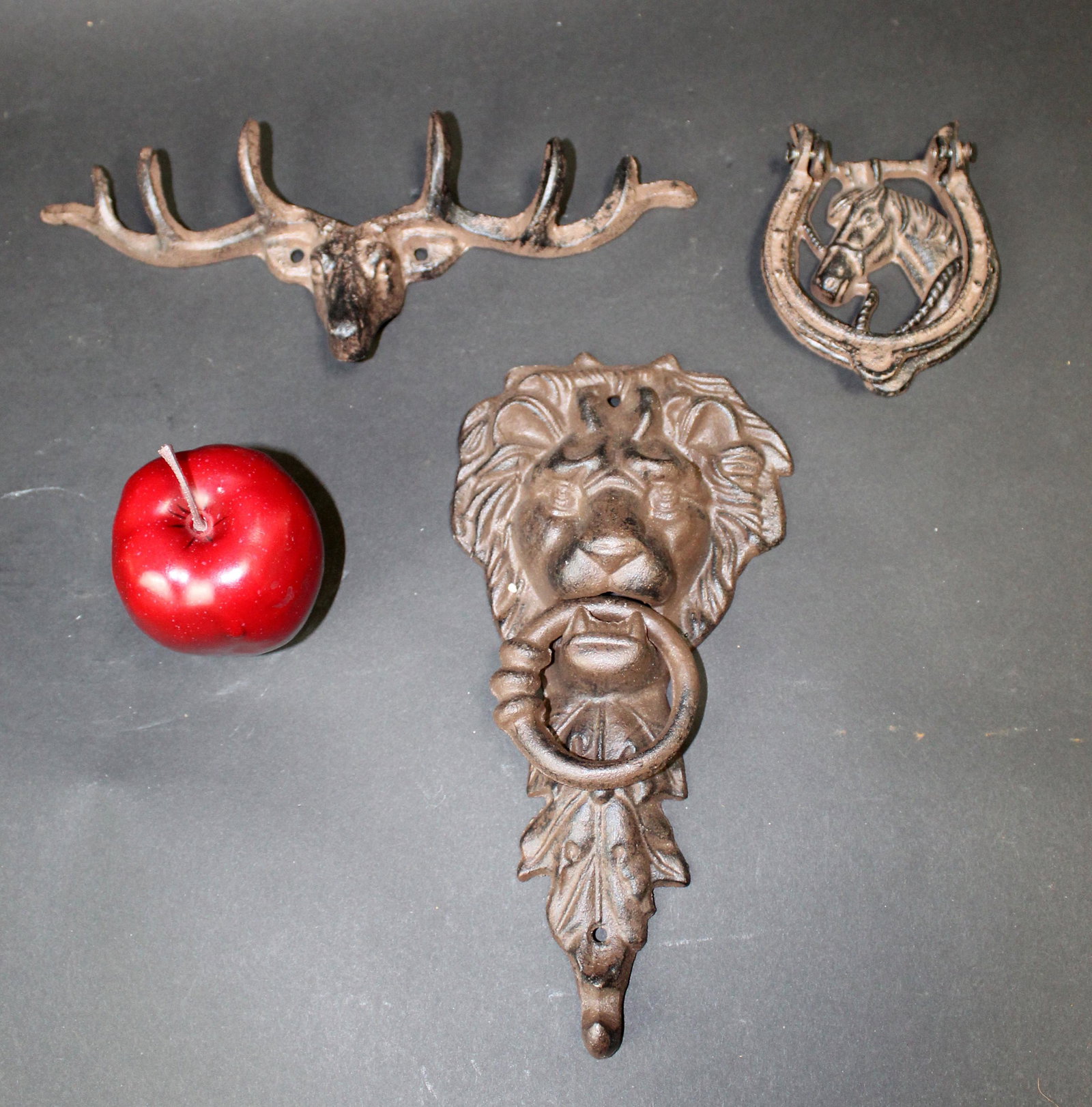 Collection of cast iron decoratives: Collection of cast iron decoratives. 21st century. Lion door knocker 11"h x 6"w, Deer hook 4"h x 11"w, horse door knocker 5"h x 4"w