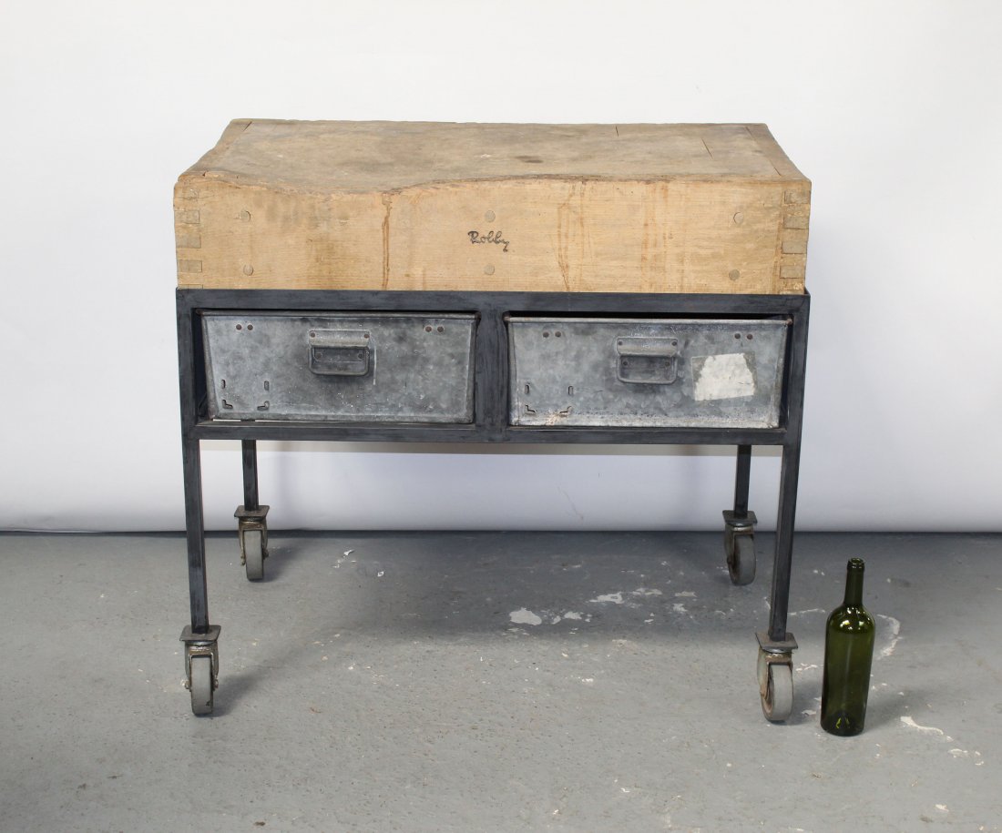 Butcher block table on industrial rolling cart: Butcher block table on industrial rolling cart with 2 drawers. Butcher block marked with maker name Robby. Mid 20th century. 36"h x 40"w x 23 1/2"d