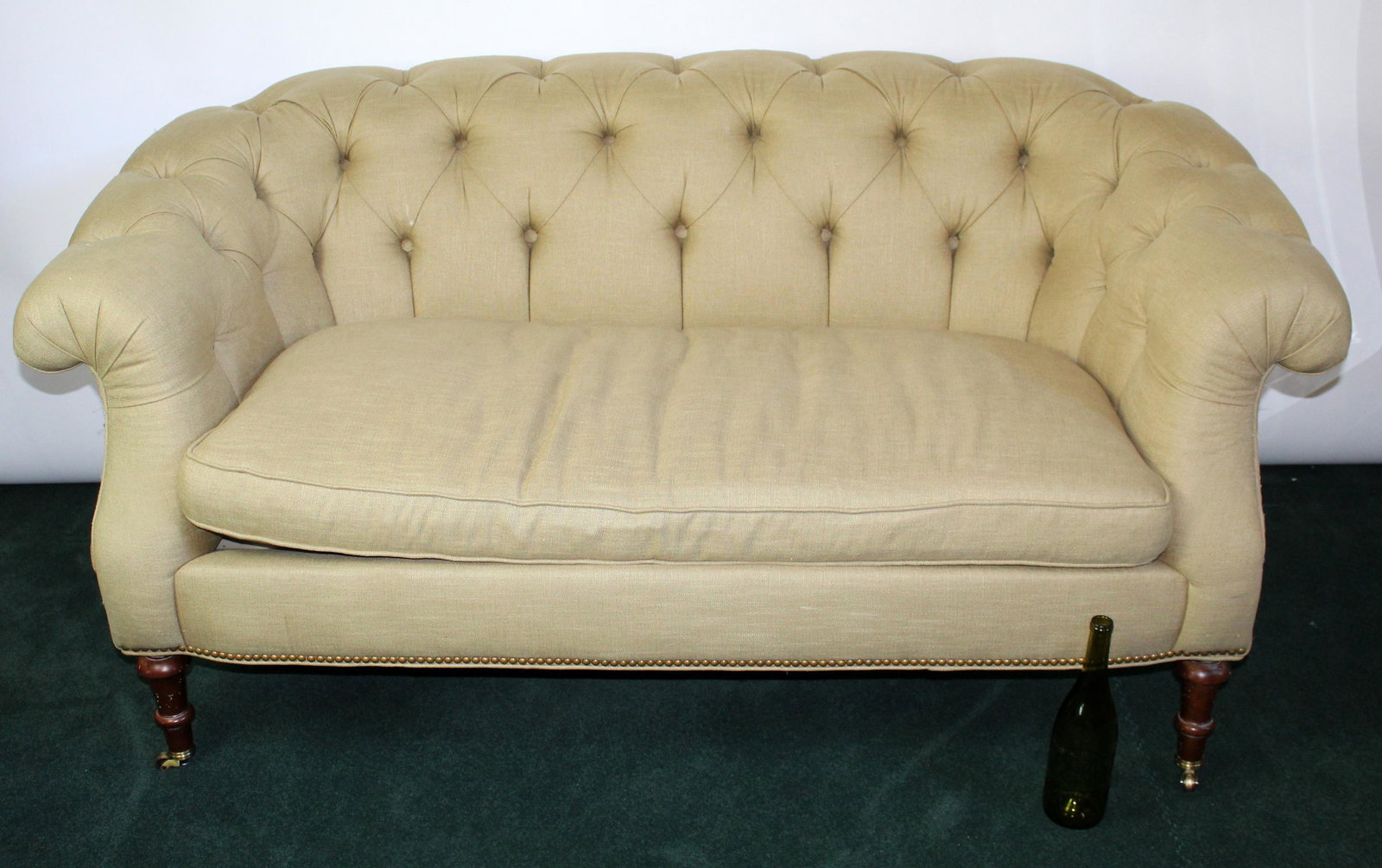 Southwood tufted upholstery settee: Southwood tufted upholstery settee on casters. Late 20th century. 31"h x 63"w x 36"d