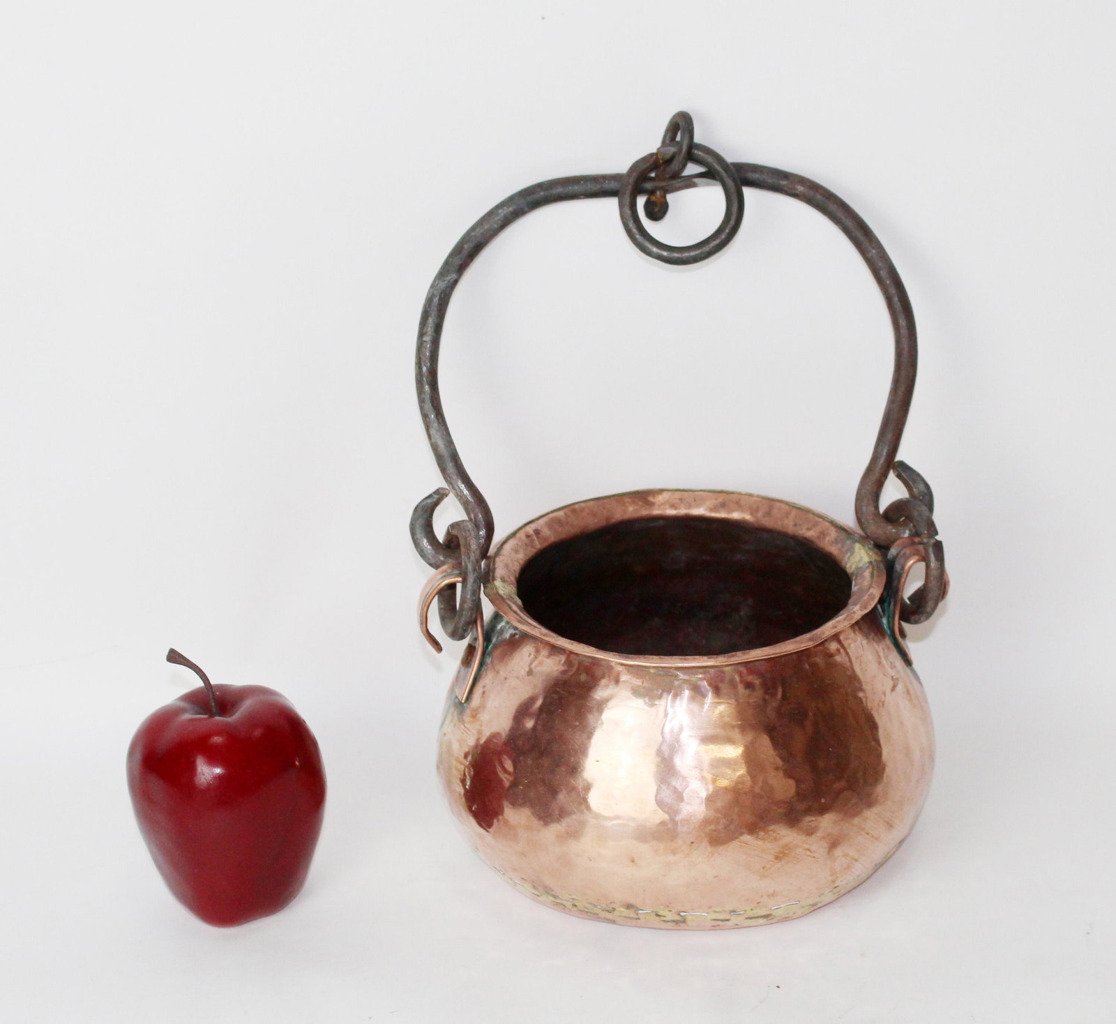 Hammered copper pot with iron handle: Hammered copper pot with iron handle. Pot measures 5"h x 8" dia, with handle measures 14 1/2"h