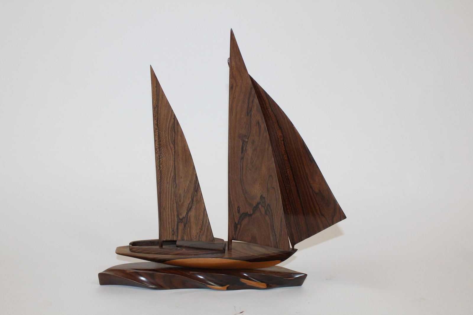 Carved rosewood model of Sailboat: Carved rosewood model of Sailboat. Circa 1970's. 16"h x 12 1/2"w