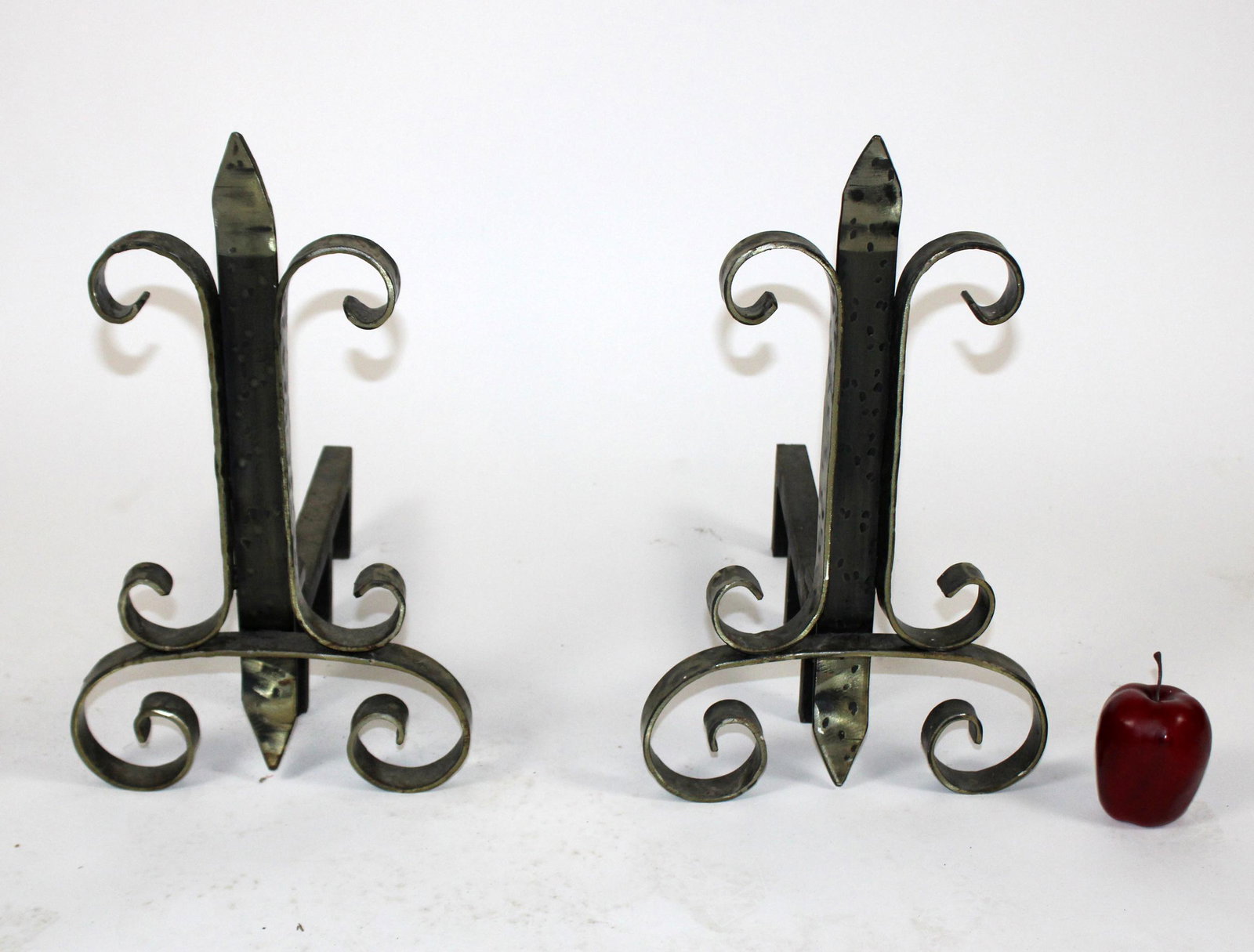 Pair of hammered iron andirons with fleur de lys: Pair of hammered iron andirons with fleur de lys. 18 1/2"h x 11"w x 18"d