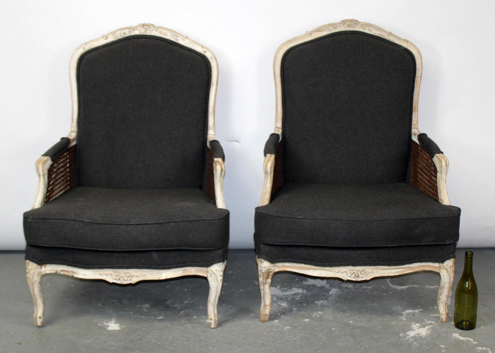 Pair of French Louis XV bergeres: Pair of French Louis XV bergeres with painted frames, caned sides, and upholstered seats & backs. Early 20th century. 41"h x 31"w x 24"d Seats are 17 1/2"h