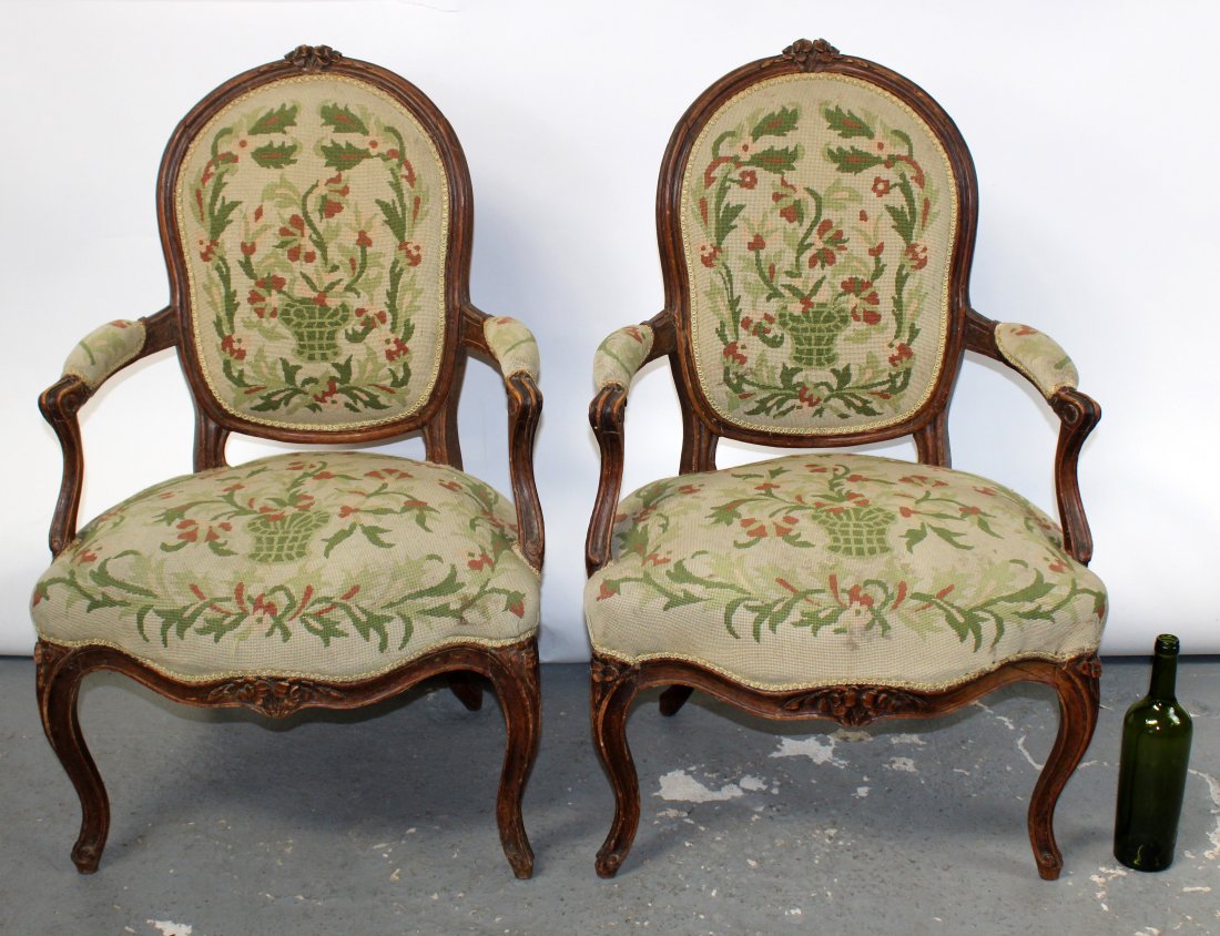 Pair of French Louis XV style armchairs with petit: Pair of French Louis XV style carved walnut armchairs with floral petit point upholstery. Late 19th century. 36"h x 22"w x 22 1/2"d. 17" seat height.