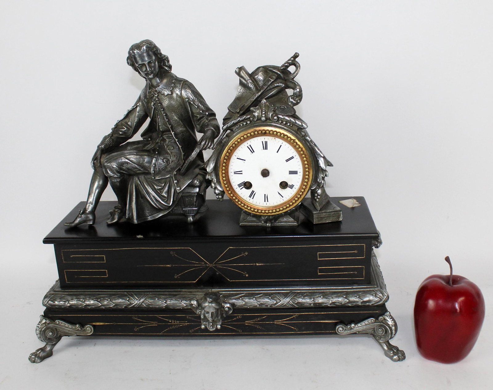 Figural mantel clock on marble base: Figural spelter mantel clock on marble base depicting a male scholar. 20th century. 14"h x 21"w x 6"d