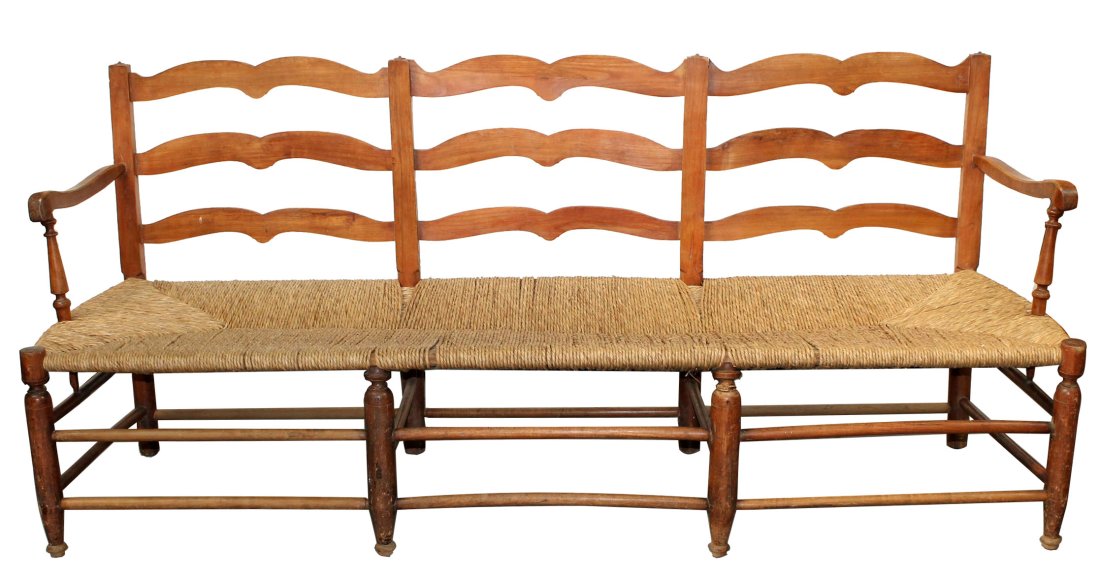 French ladder back farmhouse bench with rush seat: French carved walnut ladder back farmhouse bench with rush seat. 19th century. 34 3/4"h x 79"l x 25"d Seat 16 1/2"h