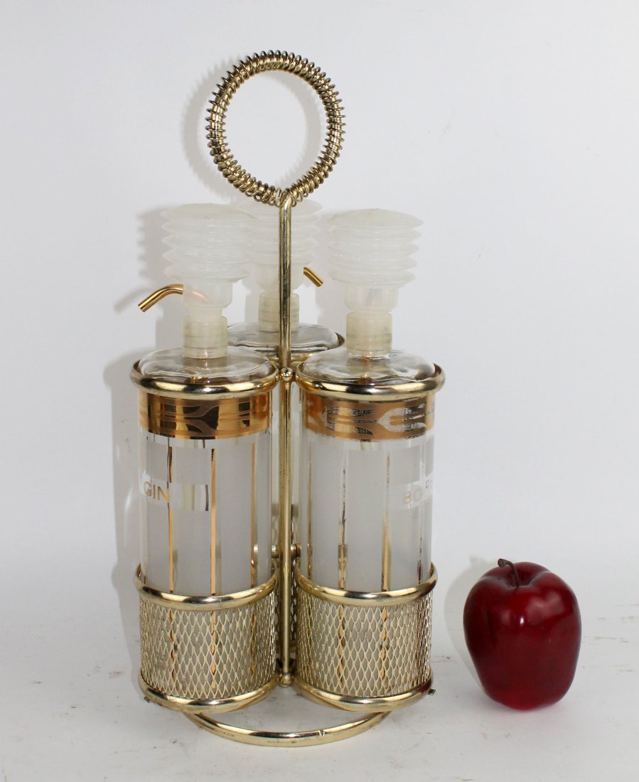 Mid century tantalus set with 3 bottles in brass carriage (1 of 9)