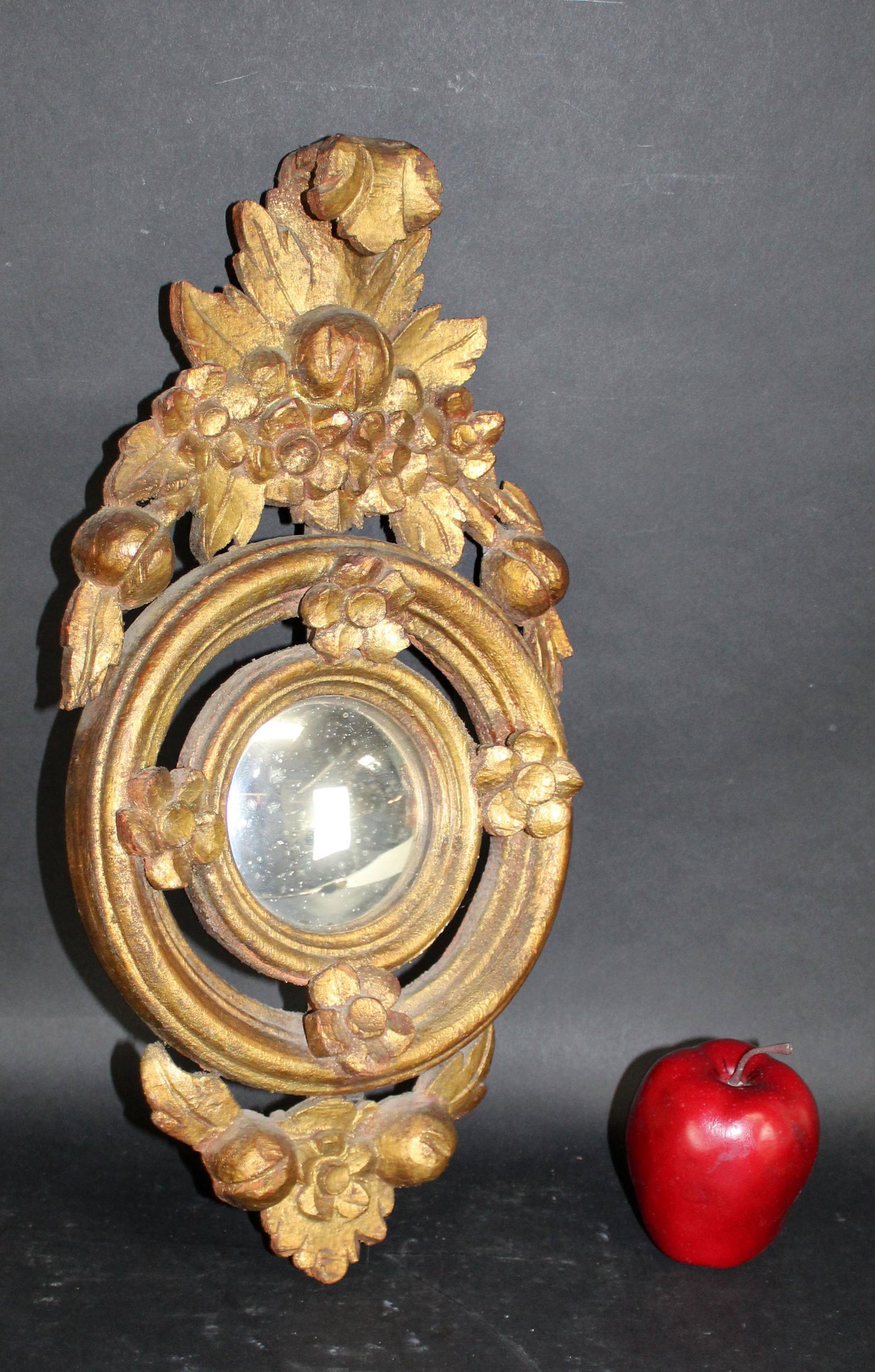 Italian gilt wood mirror with convex center: Italian gilt wood mirror with convex center. Early 20th century.18 1/4"h x 9 1/4"w x 2"d