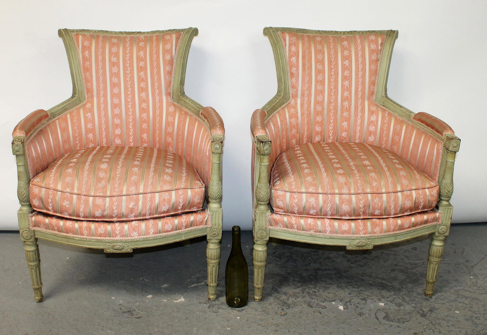Pair of French Louis XVI bergeres in painted finish: Pair of French Louis XVI bergeres in painted finish. 35 3/4"h x 27 1/4"w x 19"d, seat height 17"