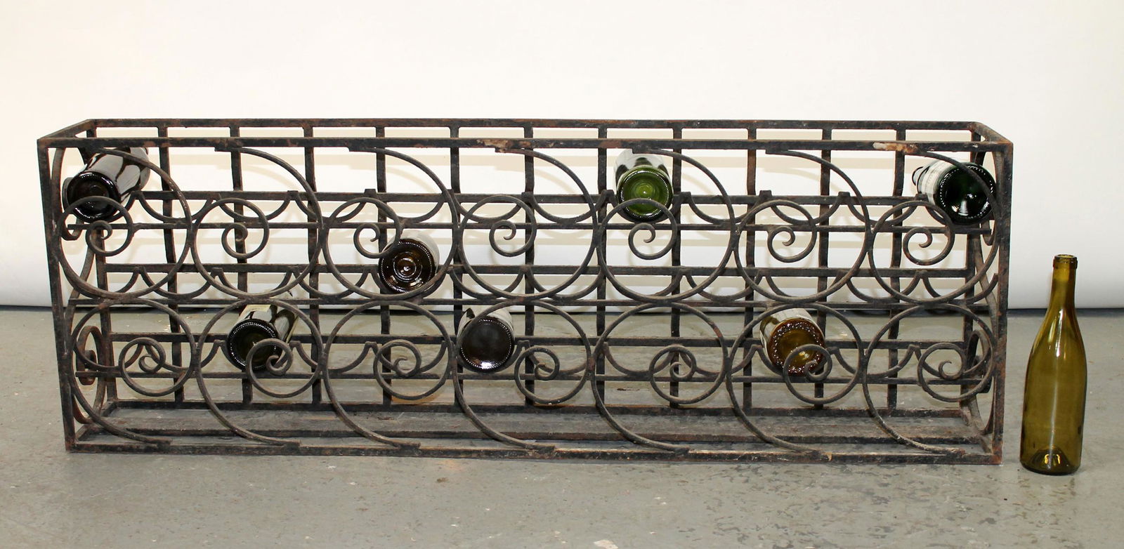 French wrought iron wine rack: French wrought iron wine rack. Late 19th century. 17 3/4"h x 51 1/4"l x 8 3/4"w