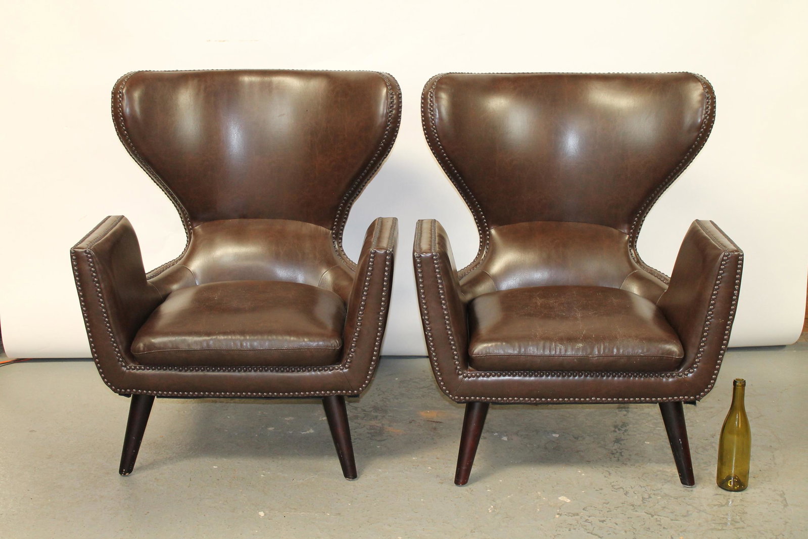 Pair modern club chairs studded faux leather: Pair modern club chairs studded faux leather. 21st century. 40 1/2"h x 33"w x 27 1/2"d Sear 17"h