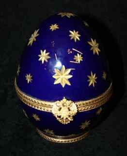 Faberge Limoges France cobalt egg with : perfume inside. Sealed. Inside of egg marked Faberge No. 004. Bottom of egg marked Faberge Limoges France Serie Limitee. 6"h x 4 3/4"l