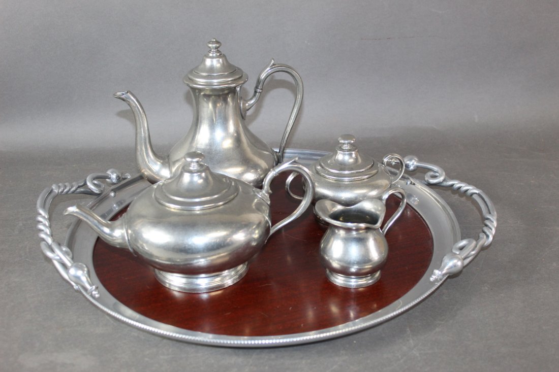 4 piece pewter tea and coffee service on vintage tray: 4 piece pewter tea and coffee service on vintage tray. Tallest 9 1/4"h x 9"w x 5 1/4"d Smallest 3 1/2"h x 4 1/4"w x 3"dia Tray 3"h x 21"w (18"dia)