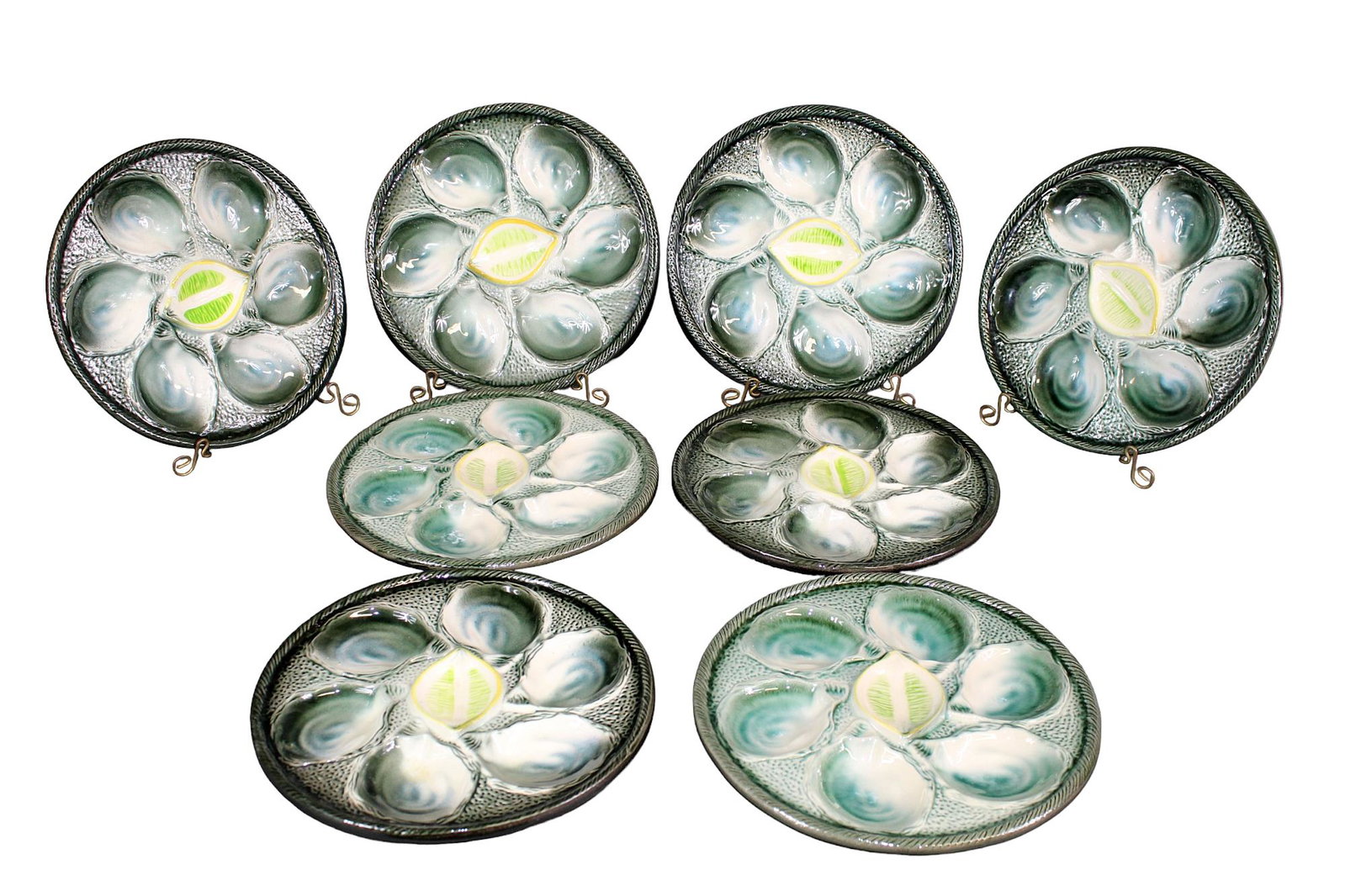 Lot of 8 French St Clement Majolica oyster plates: Lot of 8 French St Clement Majolica green & white oyster plates with trompe l'oeil lemon in center. Mid 20th century. 9 3/4" diam