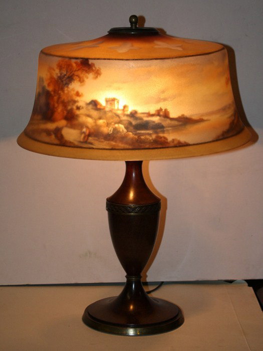 16" Pairpoint reverse painted lamp: on turned wood urn base. Shade marked The Pairpoint Corp. The cap appears to have been replaced.