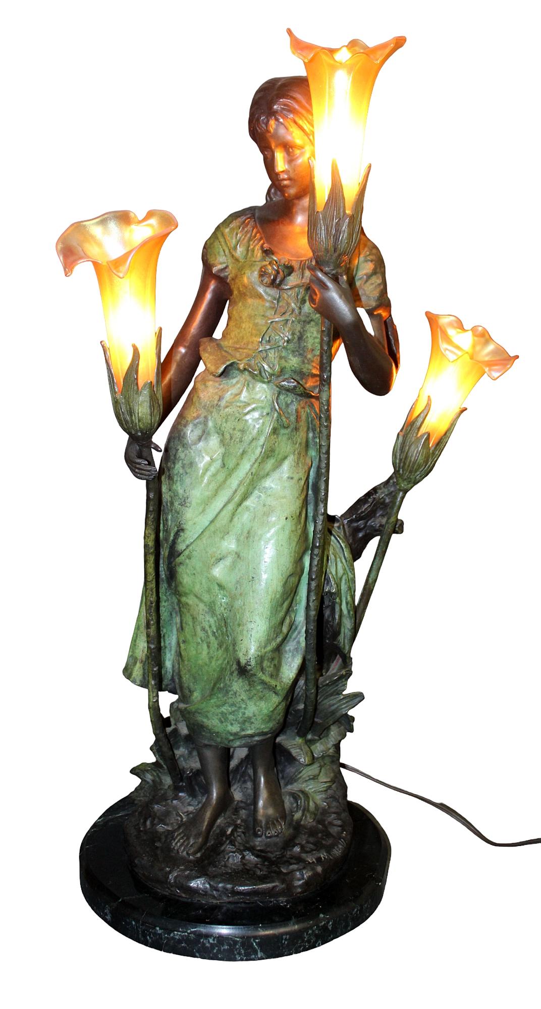 After Hippolyte Moreau bronze figural lady lamp: After Hippolyte Moreau bronze figural lady lamp with 3 art glass lily shades. On marble base. 30" h x 11 1/2" diam at base (approx)