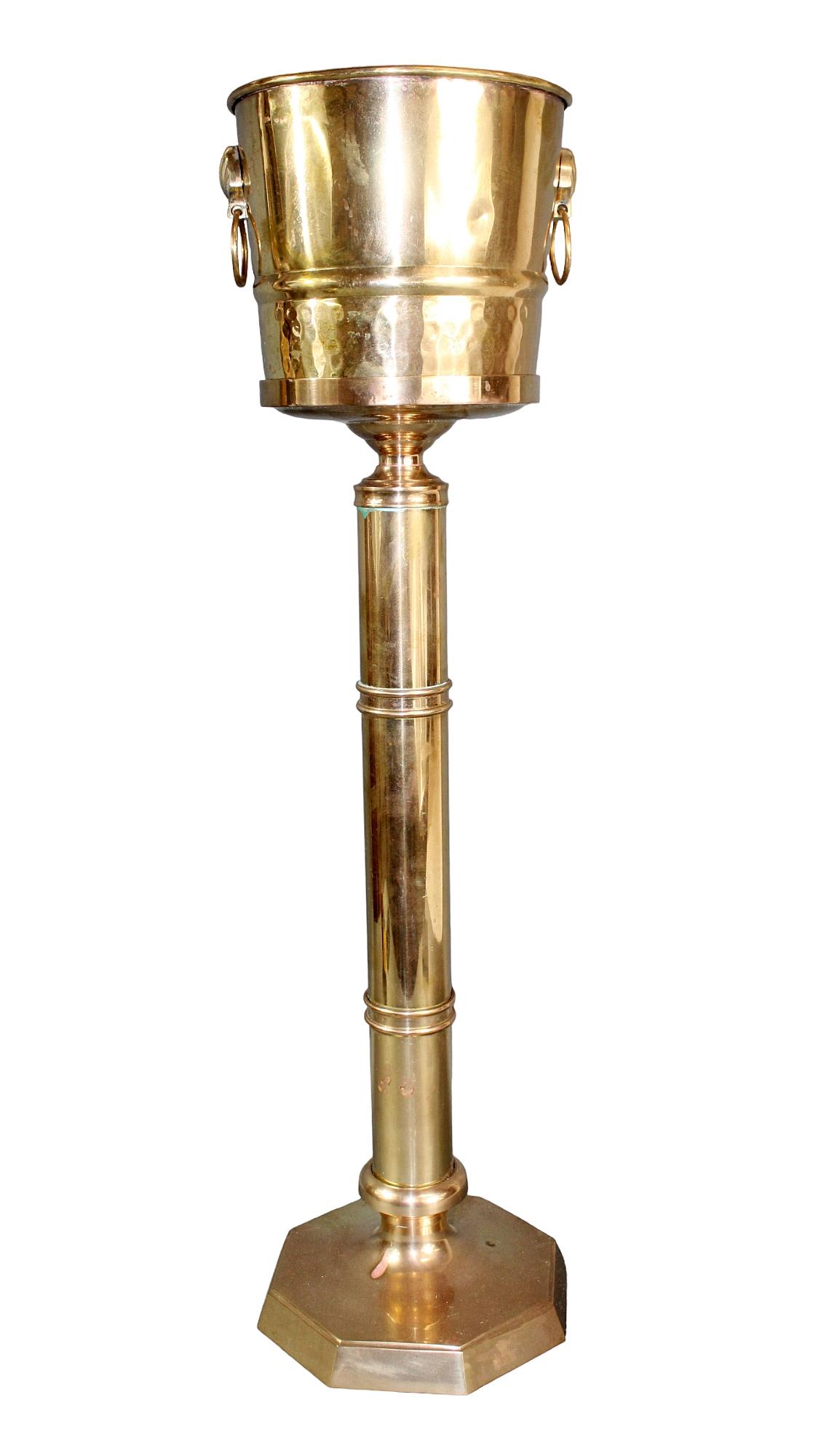 Hammered brass champagne bucket on stand: Hammered brass champagne bucket with shell and ring handles. On pedestal stand. Mid 20th century. Overall: 28 3/4" h x 7 3/4" sq. at base Stand 23"h Bucket: 6 1/2" h x 7 3/8" diam