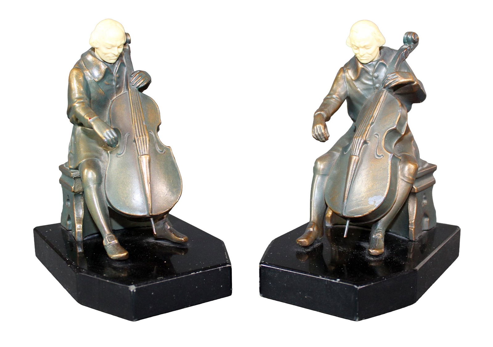Pair of JB Hirsch Ivorine book ends: Pair of JB Hirsch Ivorine bronze clad book ends of cello players, 1932. 6 1/2" h x 4" w x 5 1/4" d